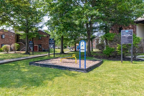 a playground in a park in front of a building