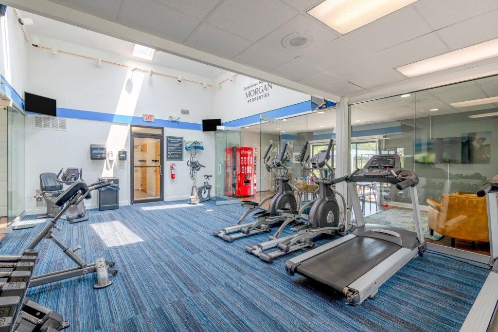 a gym with cardio machines and other exercise equipment in a building