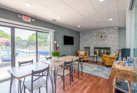 a dining room with a fireplace and a table with chairs