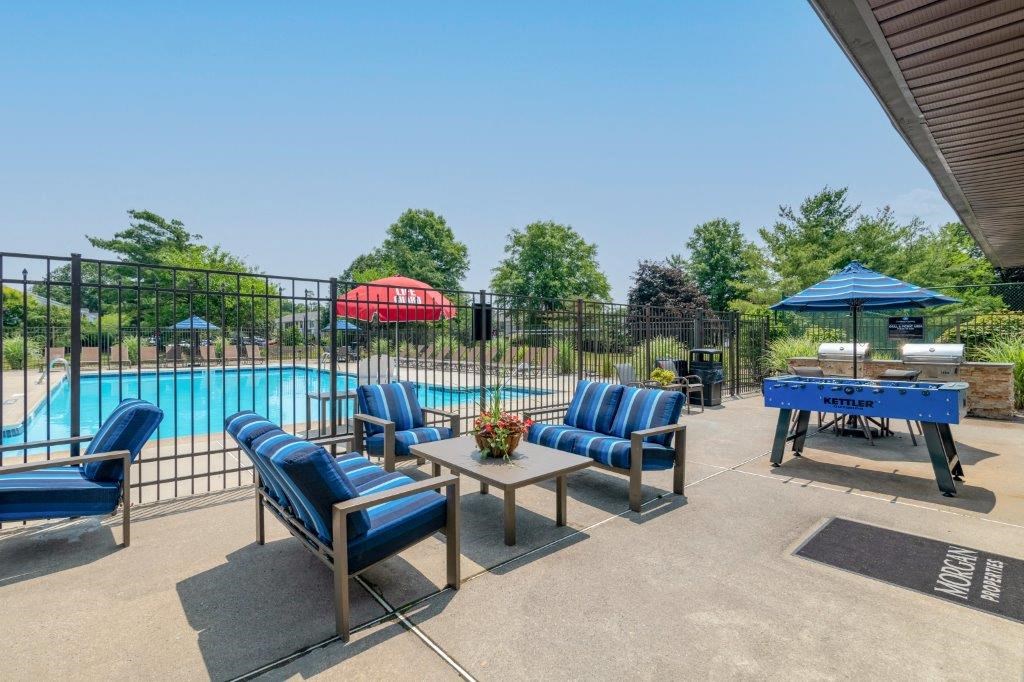 our apartments have a pool and a patio with chairs and tables