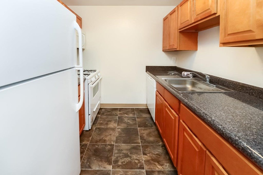 a kitchen with a sink and a refrigerator