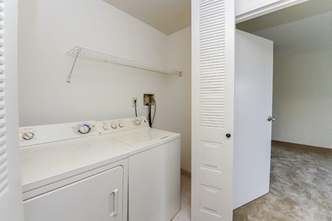 a washer and dryer in a laundry room with a closet