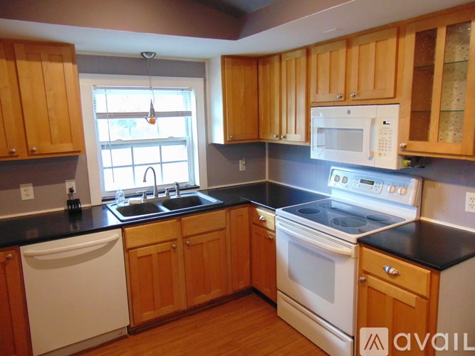 A backyard with a wooden deck and a shed.