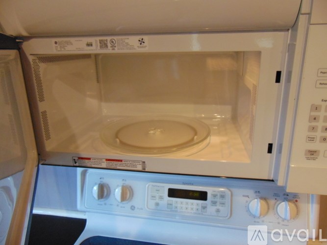 A white microwave oven with a digital display and control panel.