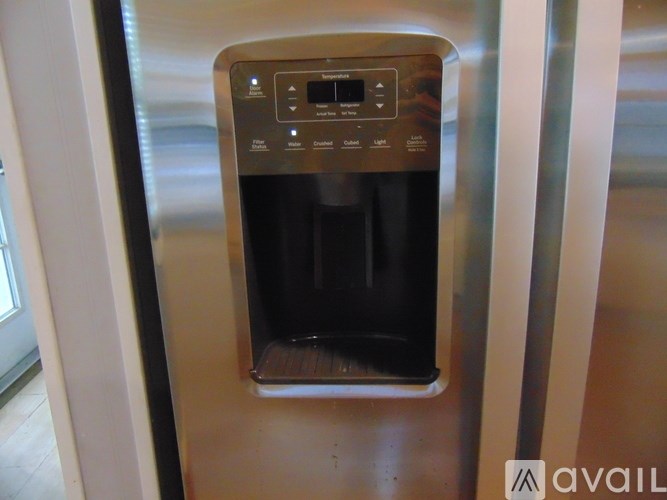 A stainless steel oven with a digital display and control panel.