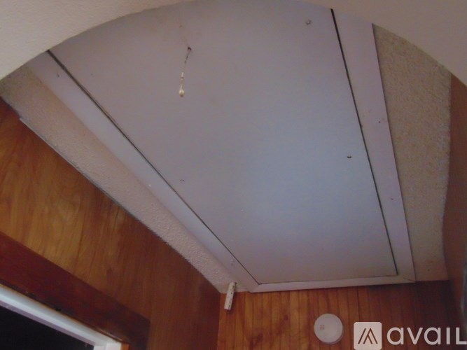 A room with a wooden wall and a white ceiling.