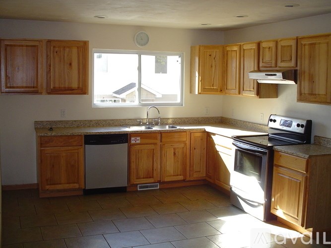 A kitchen with wooden cabinets and a stove top oven.
