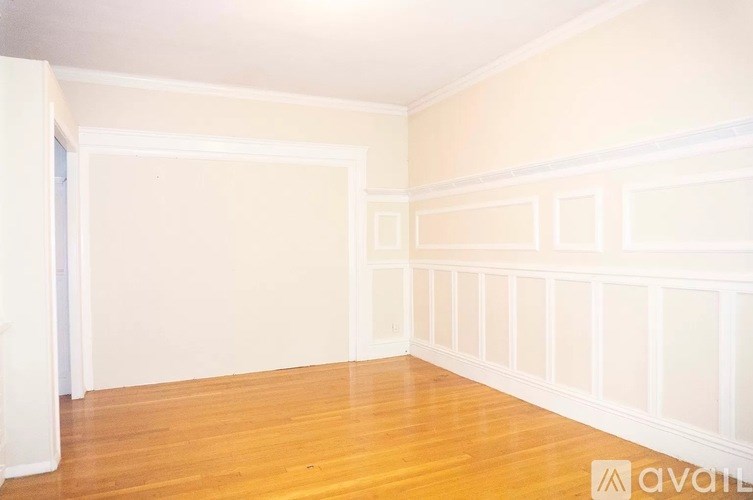 A room with wooden floors and white walls.