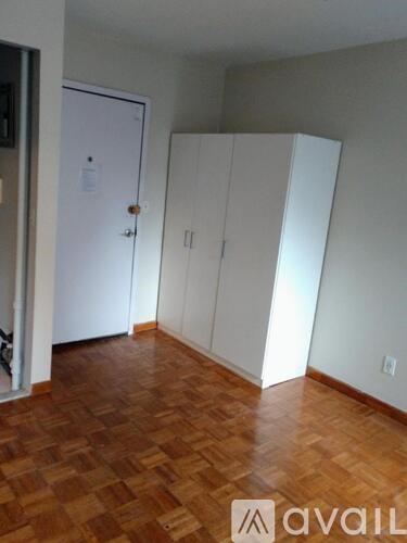 A room with a wooden floor and white walls.