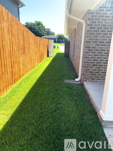 A wooden fence borders a grassy yard.