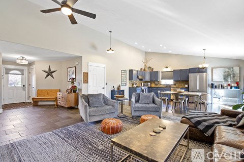 A living room with a grey couch and a wooden coffee table.