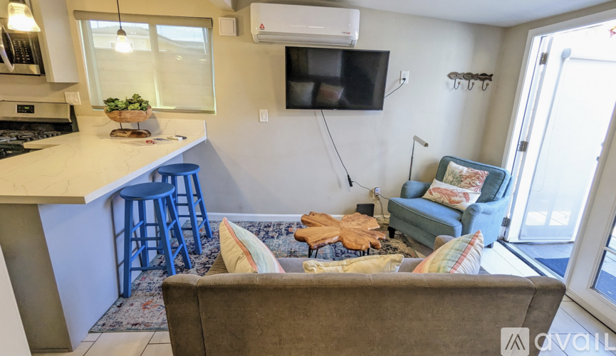 A living room with a couch and a television.