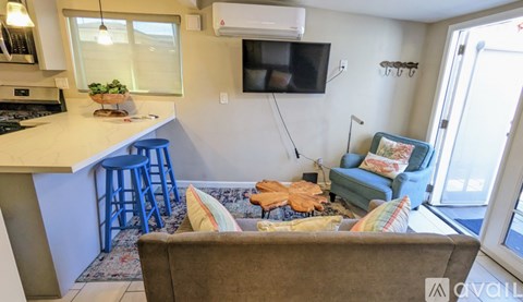 A living room with a couch and a television.
