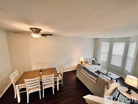 A living room with a dining table and chairs.