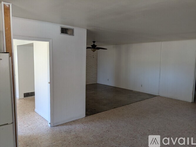 A room with a ceiling fan and a window.