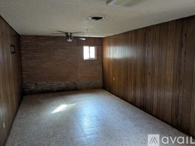A bathroom with a toilet, tub, and tiled walls.
