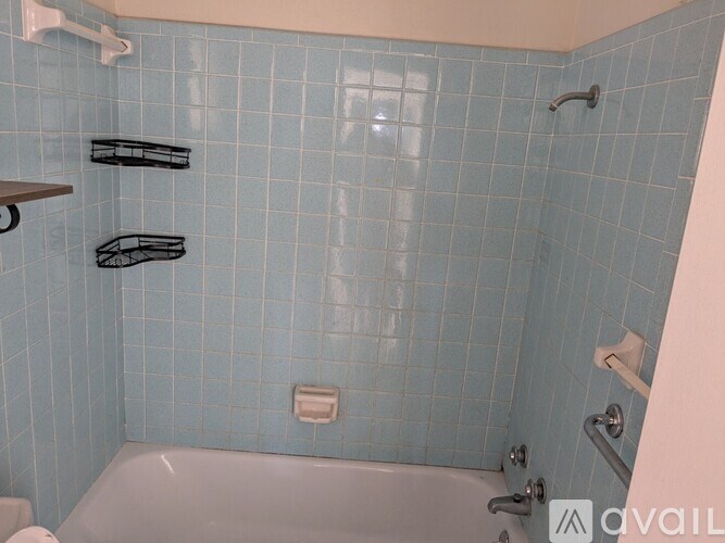 A bathroom with a toilet, sink, and mirror.