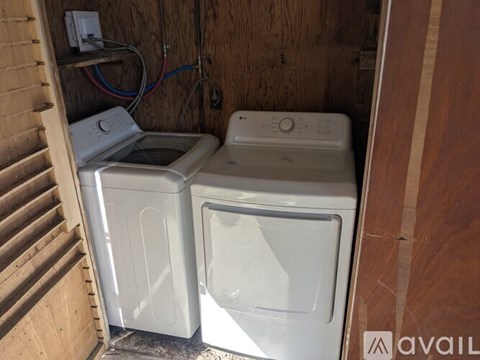 A washer and dryer are sitting next to each other in a small space.