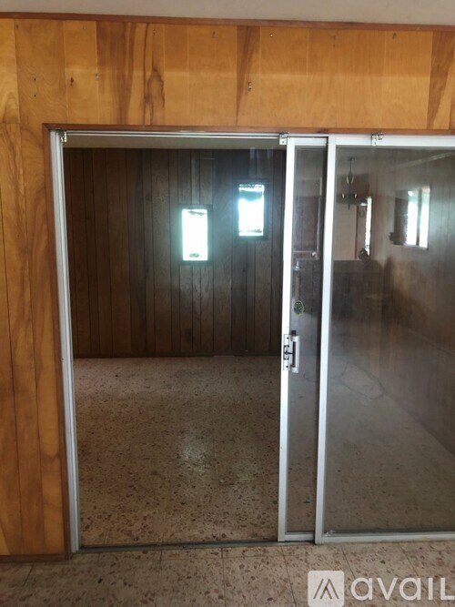 A glass door with a handle is open.