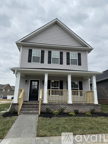 A house with a grey front and a black door.