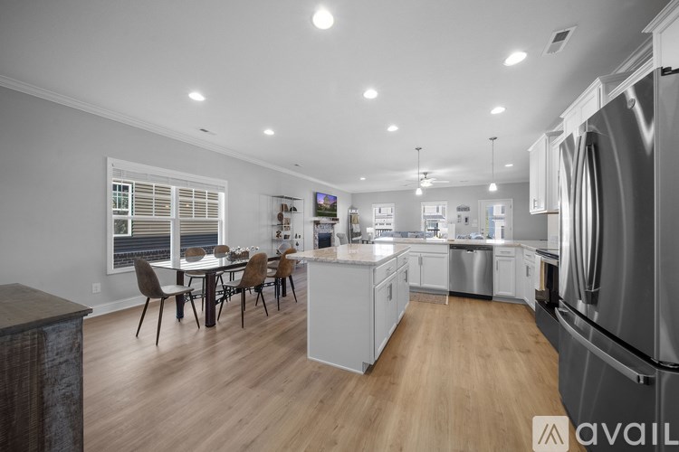 A modern kitchen with a dining table and chairs.