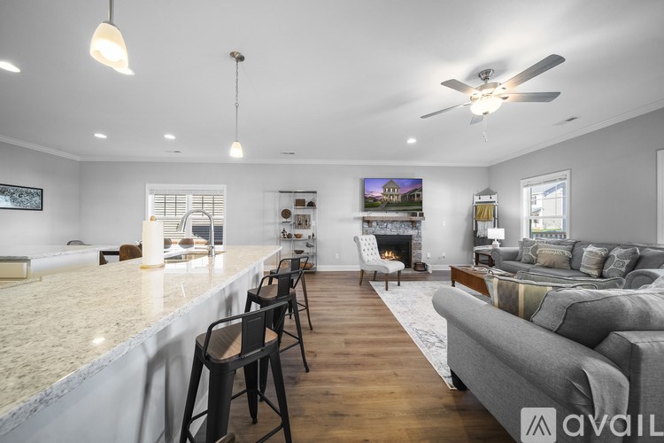A modern living room with a grey sofa and a fireplace.