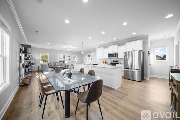 A modern kitchen with a dining table and chairs.