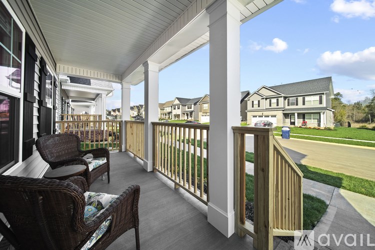 A sunny day at a residential area with a balcony overlooking the neighborhood.