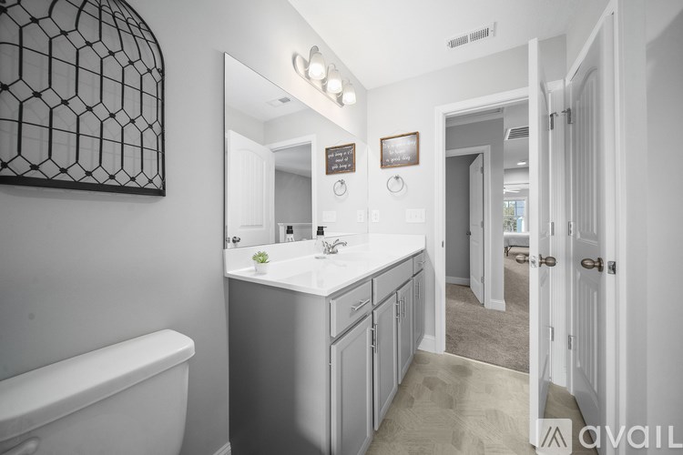 A bathroom with a white tub and sink.
