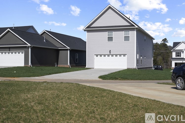 A house with a grey roof and a white garage door.