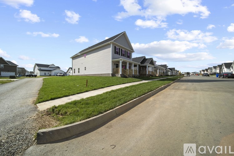 A row of houses with a road in front of them.