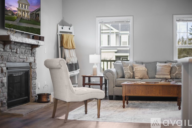 A living room with a fireplace and a chair.