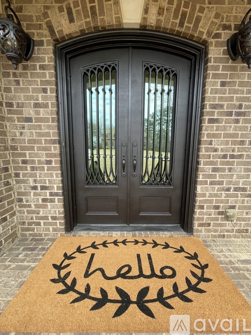 A black double door with a glass panel and sidelights.