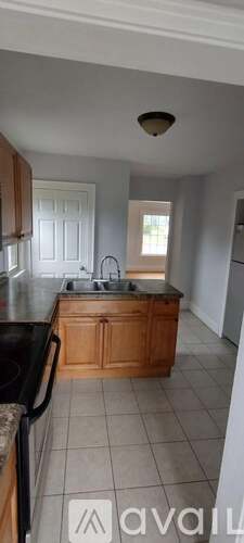 A kitchen with wooden cabinets and a black countertop.