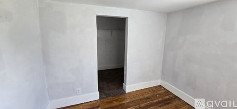 A room with a doorway leading to another room.