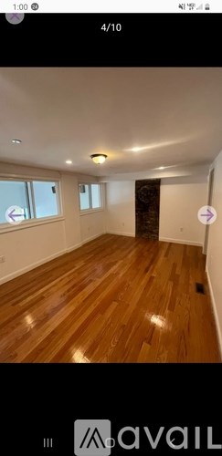 A room with wooden flooring and a window.