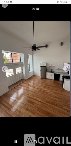 A room with wooden flooring and a ceiling fan.