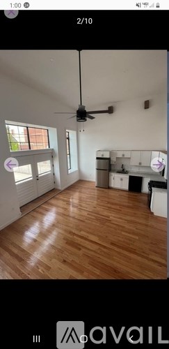 A room with wooden flooring and a ceiling fan.