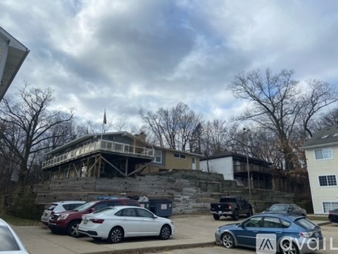 A parking lot with cars and a building under construction.