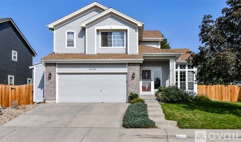 A two-story house with a garage is for sale.