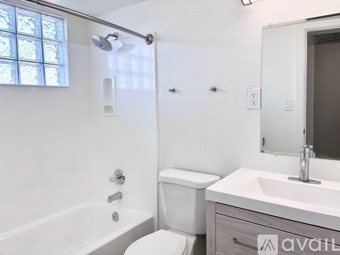 A white bathroom with a tub, toilet, and sink.