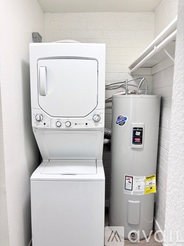 A white washing machine and dryer in a small laundry room.