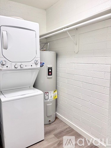 A white dryer and washer are in a small laundry room.