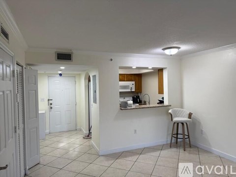 A kitchen area with a bar stool and a countertop.