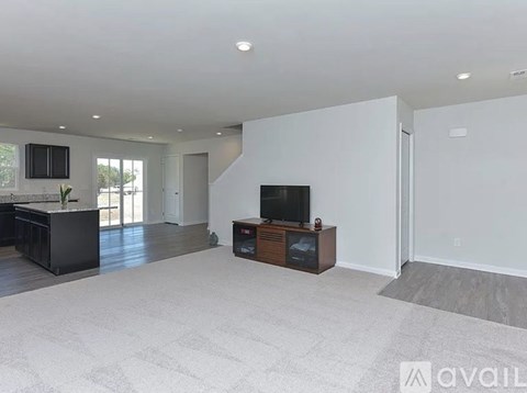 A spacious living room with a television and a bar area.