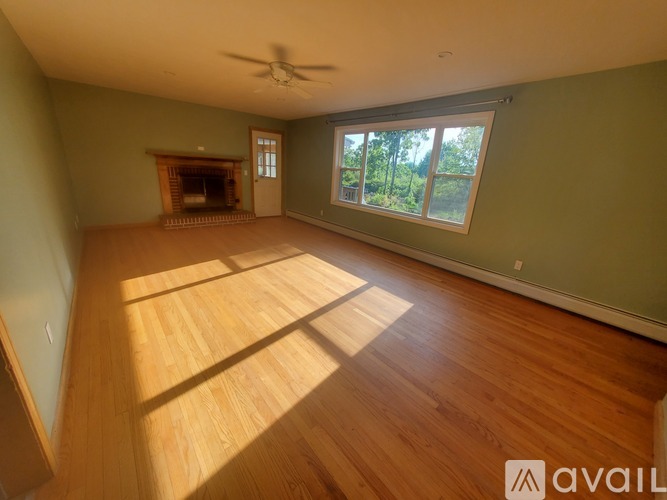 A room with a fireplace and a ceiling fan.