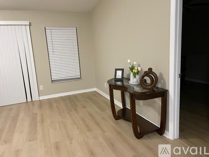 A room with a wooden table and a clock on it.