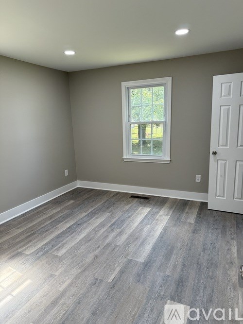 A room with a window and a door.