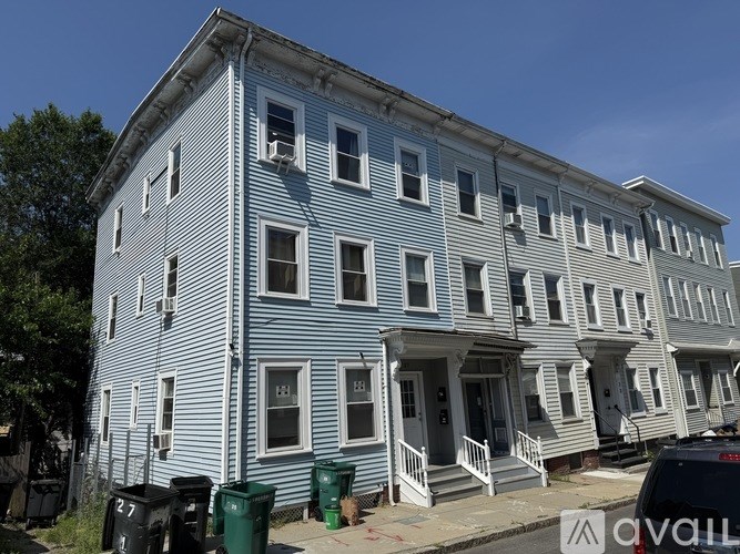 A row of houses with blue and white siding.
