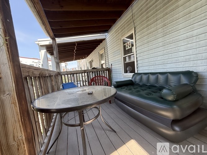 A patio with a table, chairs, and a sofa.